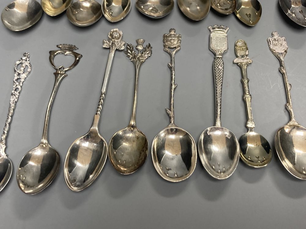 A silver dwarf candlestick, two silver condiments and a group of assorted silver, white metal and plated mainly commemorative spoons,